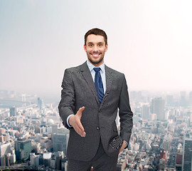 Image showing businessman with open hand ready for handshake