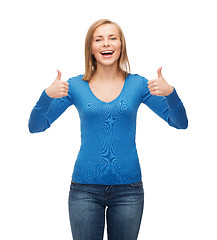 Image showing smiling girl in casual clothes showing thumbs up