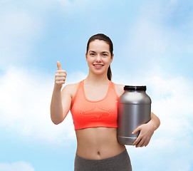 Image showing teenage girl with jar of protein showing thumbs up