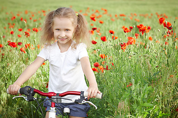 Image showing Happy smiling little girl with bicycle