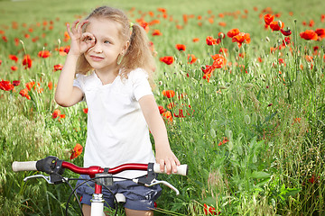 Image showing Happy smiling little girl with bicycle
