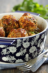 Image showing Meatballs in a blue pot on a wooden table.