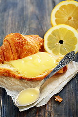 Image showing Lemon curd and teaspoon on a slice of fresh croissant.  