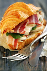 Image showing Croissant with ham and cheese close up.