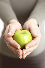 Image showing Woman holding a green apple