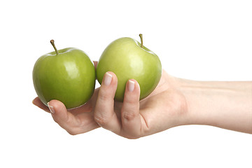 Image showing Female hand with two green apples