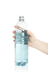 Image showing Woman opens a water bottle