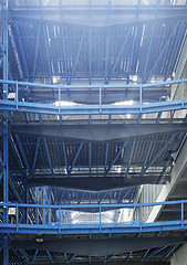 Image showing Rows of shelves with boxes in factory warehouse 