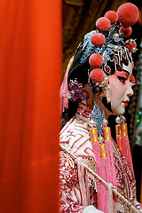 Image showing chinese opera dummy and red cloth as text space ,it is a toy,not