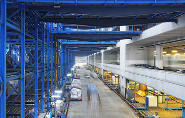 Image showing Rows of shelves with boxes in factory warehouse 