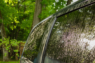 Image showing Strong rain water drops fall and splash car roof 