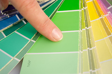 Image showing woman finger on color palette of green shade slip 