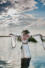 Image showing Beautiful woman with flower wreath in watet