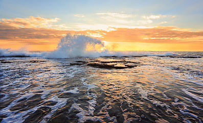 Image showing Sunrise seascape splash in the shape of a wave