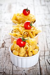 Image showing uncooked pasta and cherry tomatoes in three bowls 