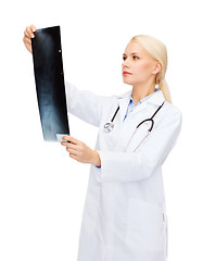 Image showing serious female doctor looking at x-ray