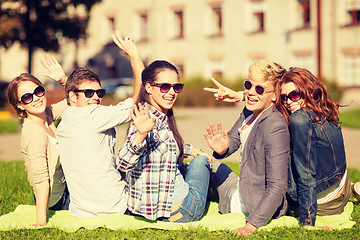 Image showing group of students or teenagers waving hands