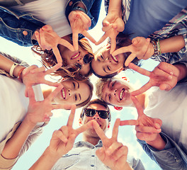 Image showing group of teenagers showing finger five