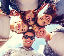 Image showing group of teenagers looking down