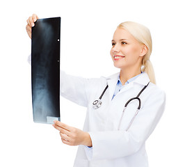 Image showing smiling female doctor looking at x-ray