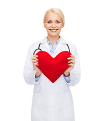 Image showing smiling female doctor with heart and stethoscope