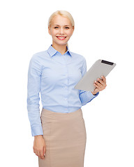 Image showing smiling woman looking at tablet pc computer