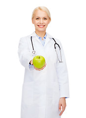 Image showing smiling female doctor with green apple