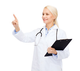 Image showing smiling female doctor pointing to something