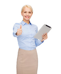 Image showing smiling woman looking at tablet pc computer