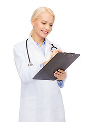 Image showing smiling female doctor with clipboard