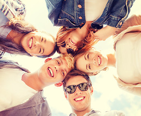 Image showing group of teenagers looking down