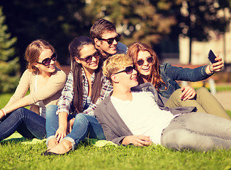 Image showing teenagers taking photo outside with smartphone