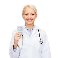 Image showing smiling female doctor with pills