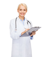 Image showing smiling female doctor with clipboard