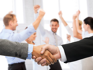 Image showing businessman and businesswoman shaking hands