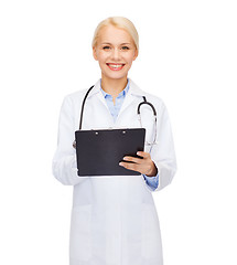 Image showing smiling female doctor with clipboard