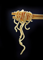 Image showing Chopsticks with noodles