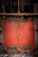 Image showing Gray steel wall with the red door