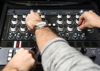 Image showing Hands on a sound mixer