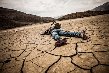 Image showing person lays on the dried ground