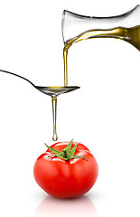 Image showing red tomato and pouring oil isolated on white