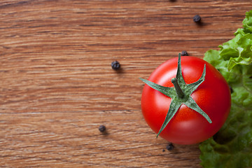 Image showing red tomato with green salad on wood