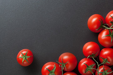 Image showing red tomatoes on black. top view