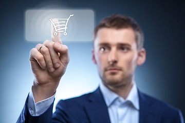 Image showing businessman press button with shopping cart