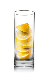 Image showing falling lemon slices inside glass isolated