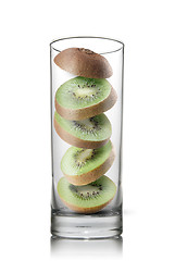 Image showing falling kiwi slices inside glass isolated