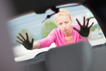 Image showing Woman pushing a car.