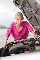 Image showing Stressed Young Woman with Car Defect.