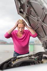 Image showing Stressed Young Woman with Car Defect.