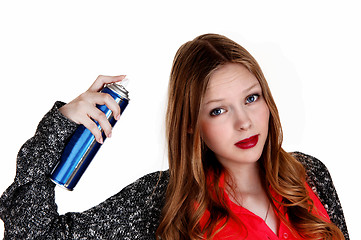 Image showing Girl putting hairspray on.